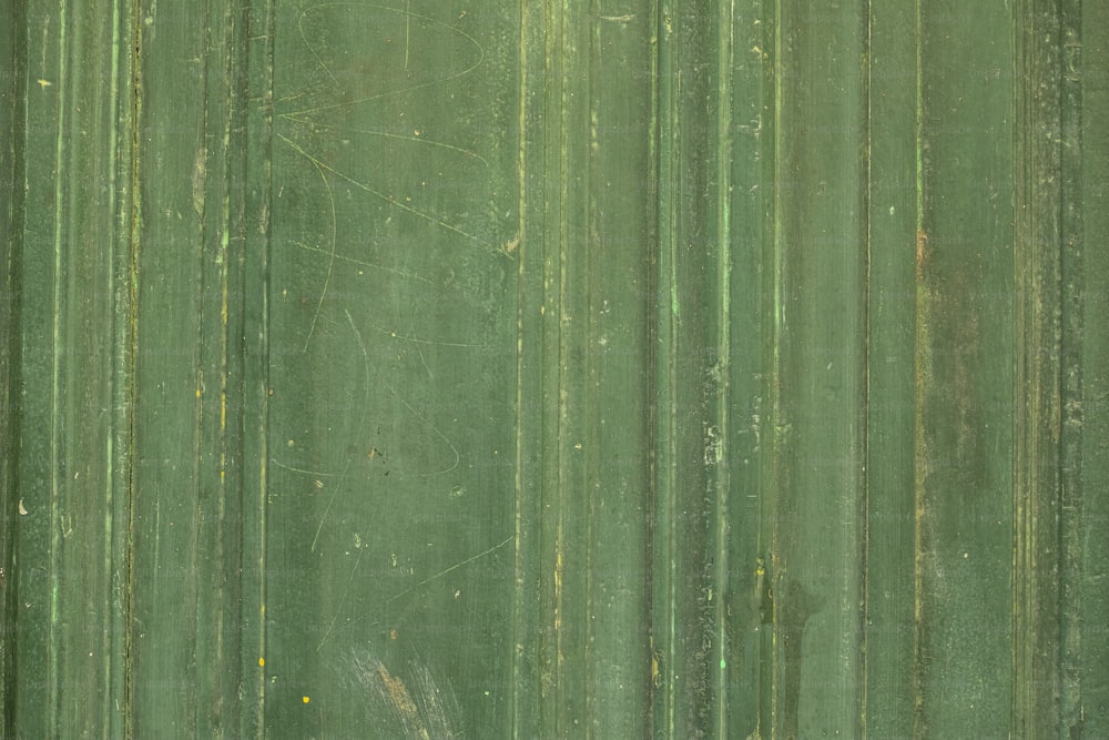 a close up of a green metal surface