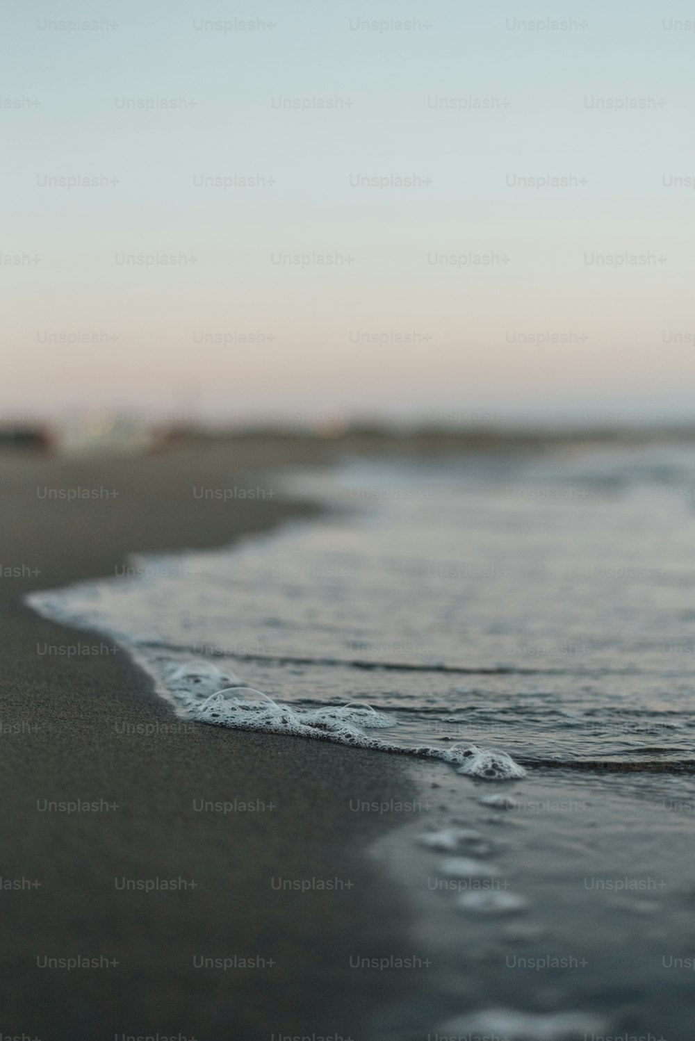 a beach with waves coming in to the shore