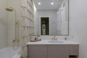 a bathroom with a sink, mirror and bathtub