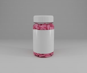 テーブルの上に座っているピンクの錠剤で満たされた瓶