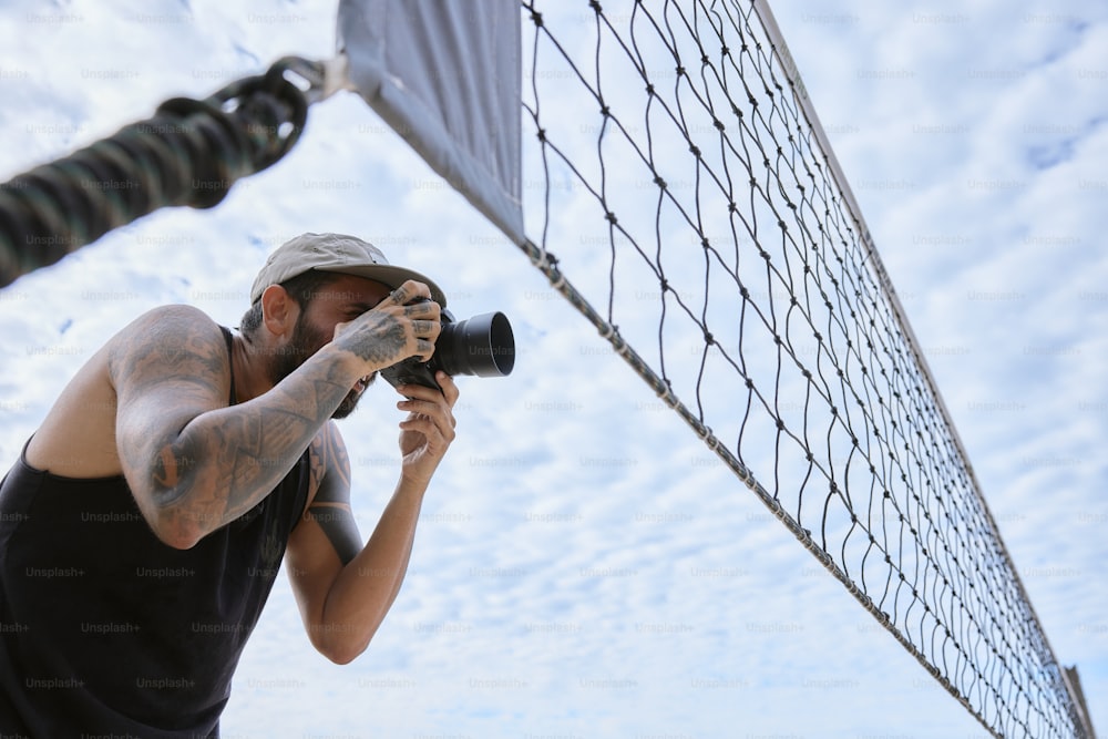 Ein Mann fotografiert ein Tennisnetz