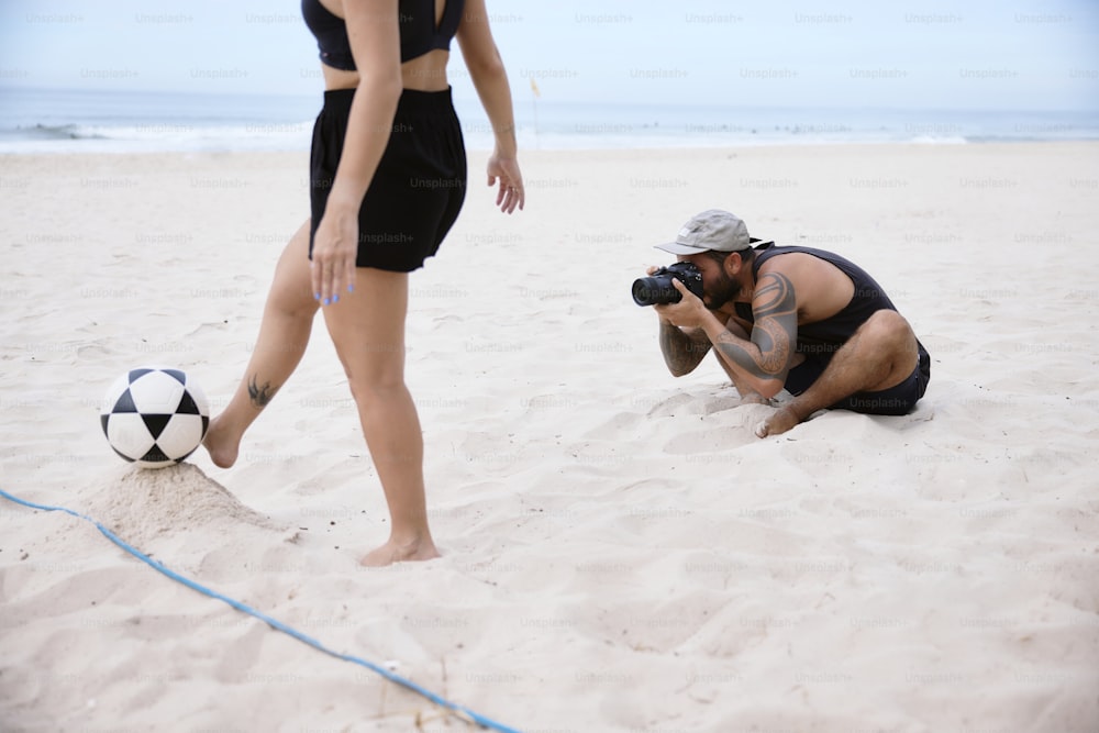 ビーチで女性の写真を撮る男性