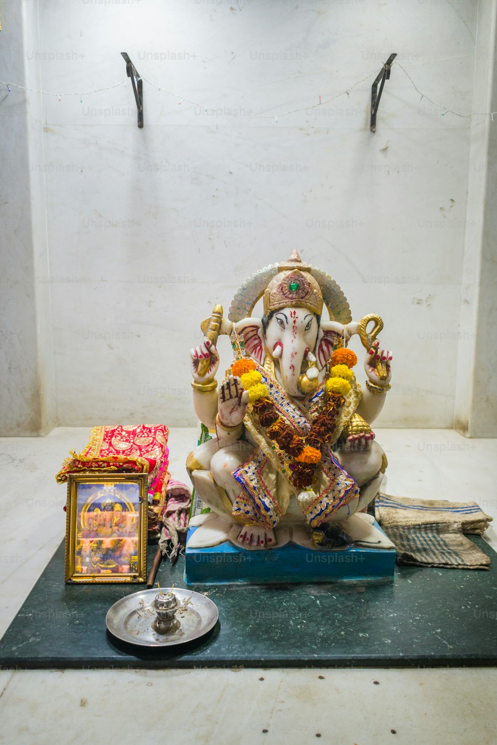 a statue of an elephant sitting on top of a table