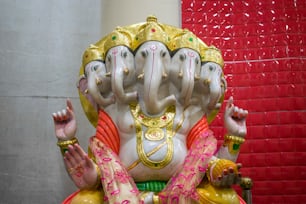 a statue of an elephant with its trunk in the air