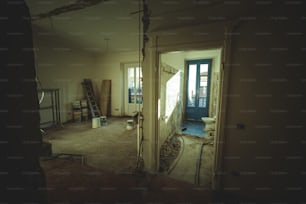 an empty room with a ladder and a window