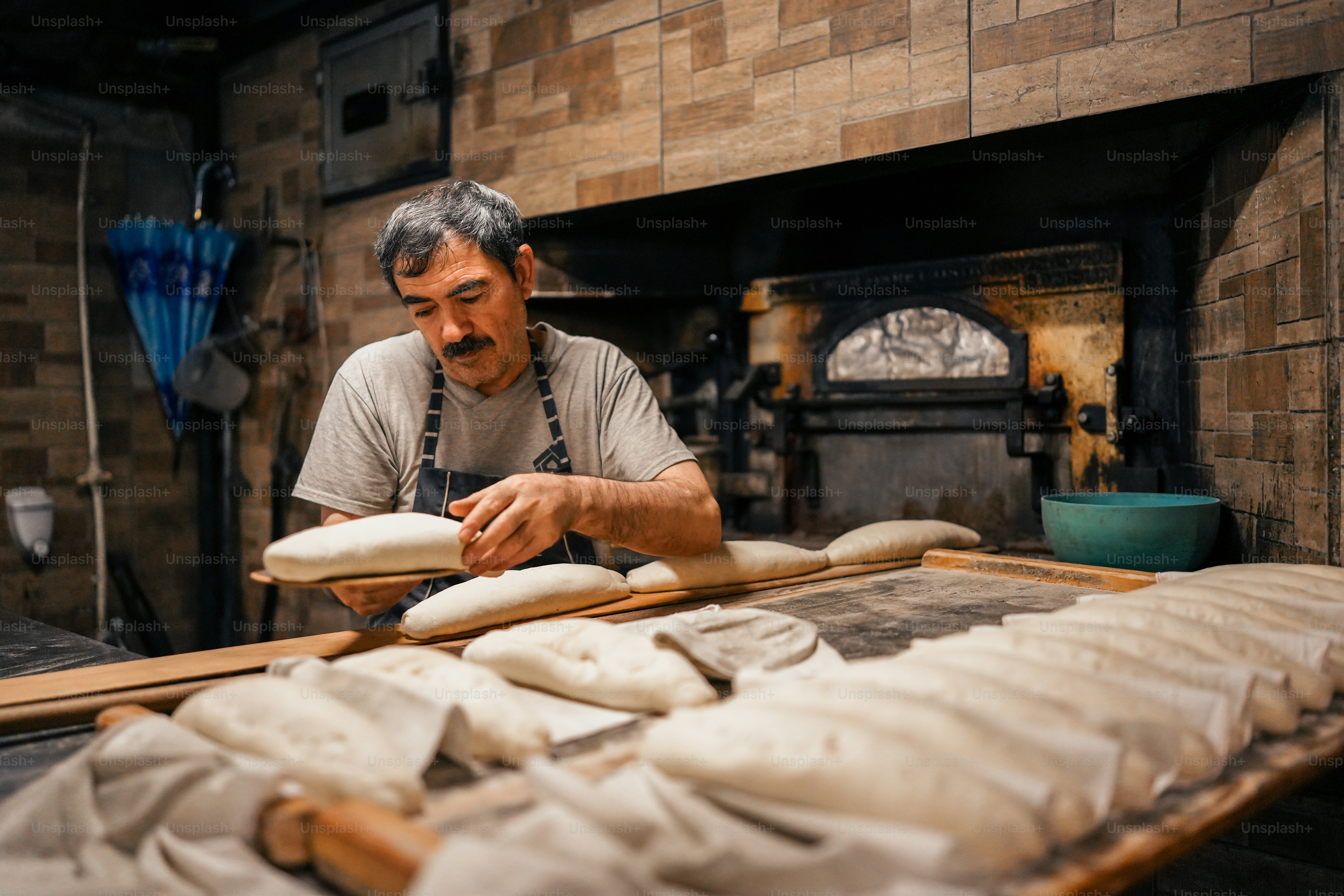 a man working in a bakery making bread