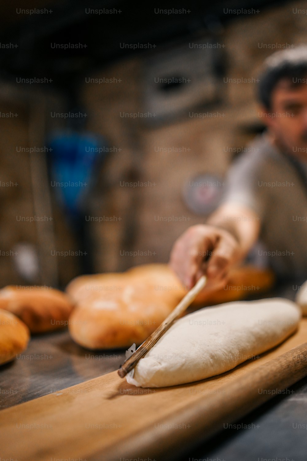 a man is making bread on a cutting board