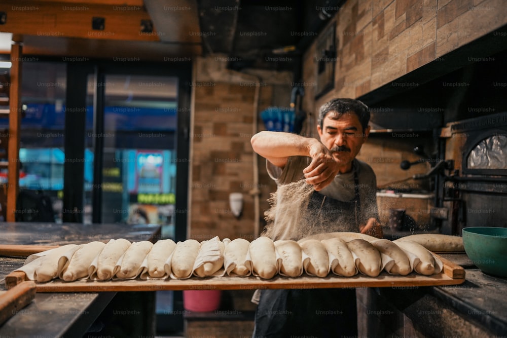a man is making bread in a kitchen