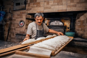 a man is making bread in a kitchen