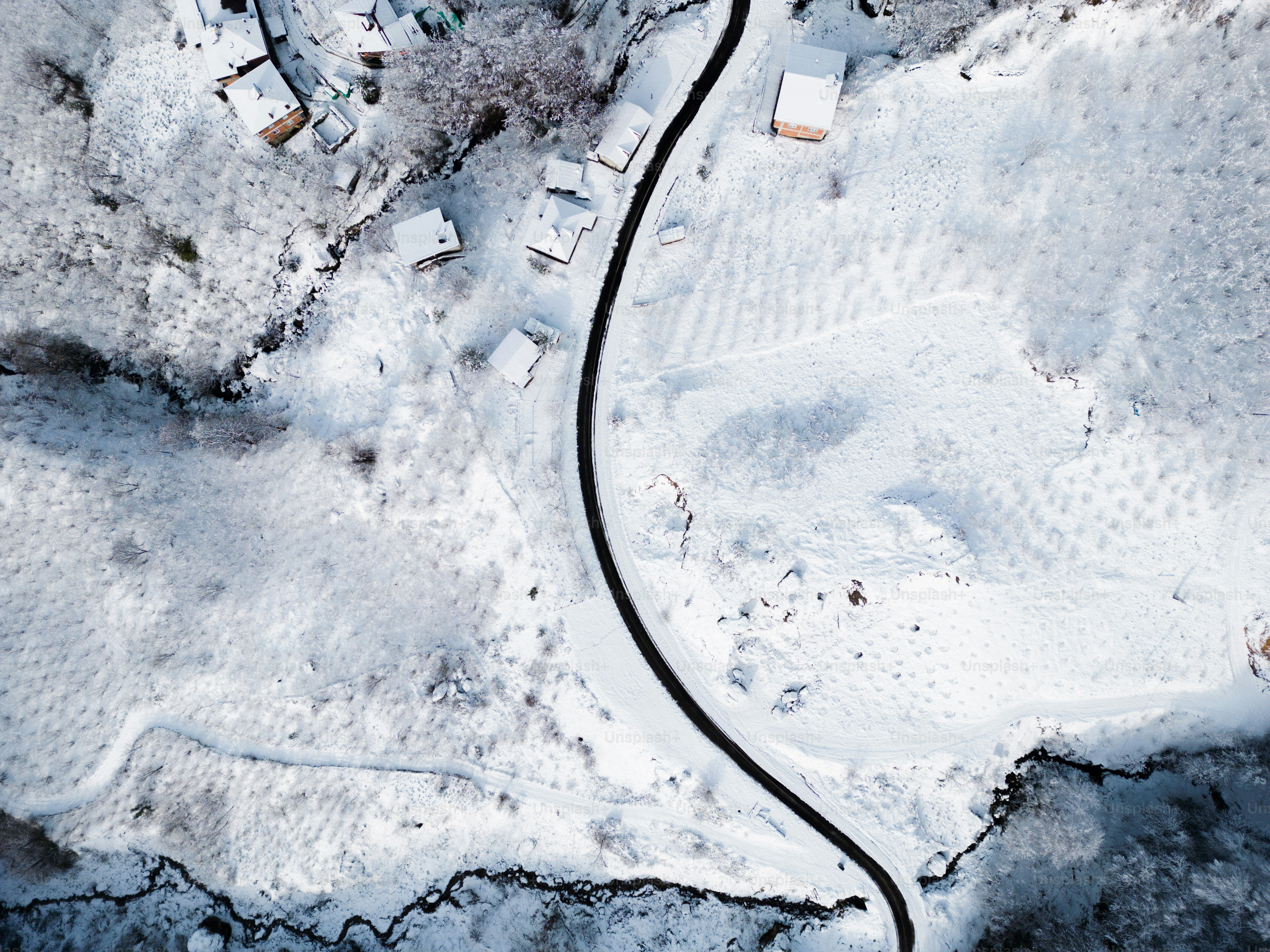 An aerial view of a village in the mountains photo – Mountains Image on ...