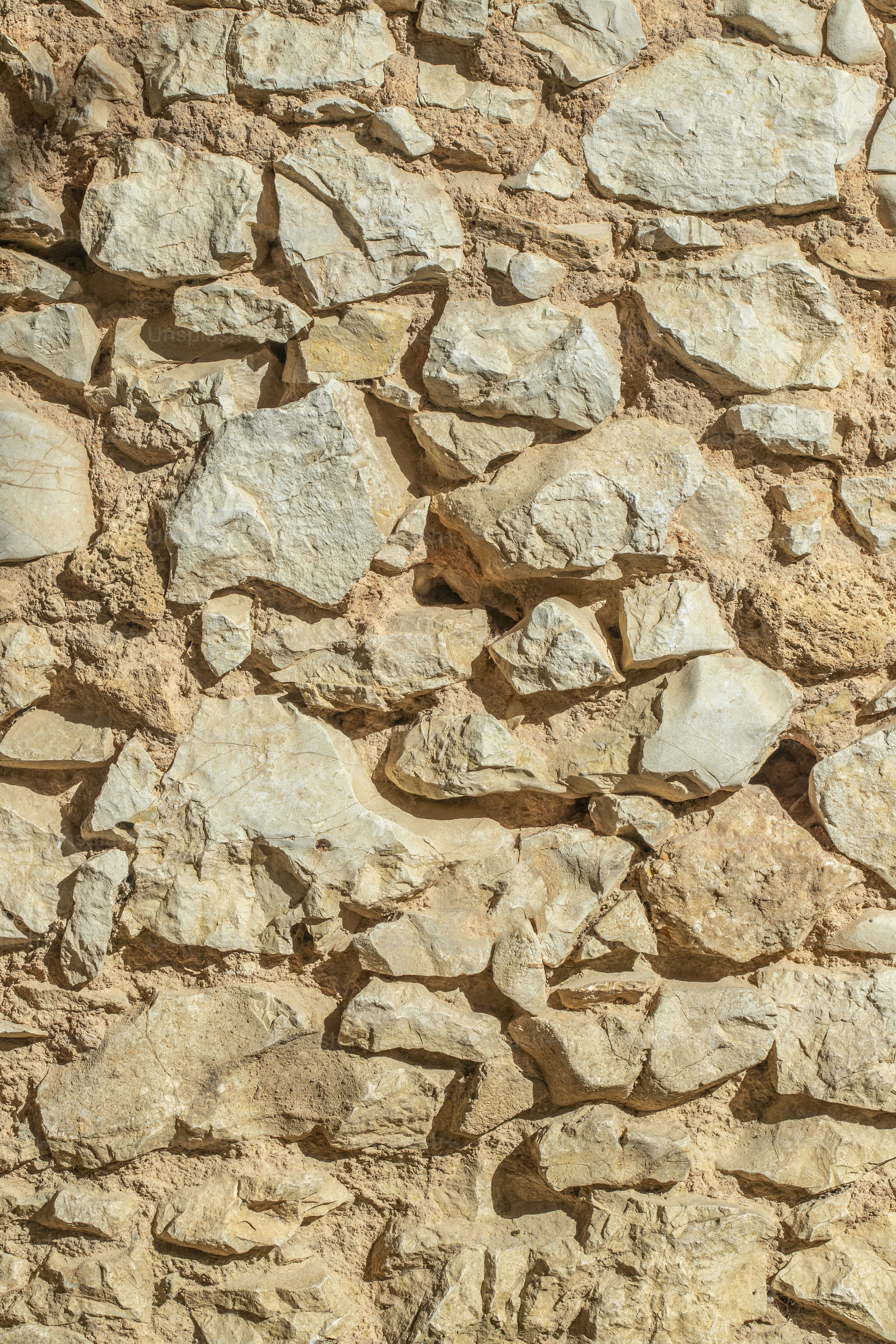 a stone wall with a clock on it