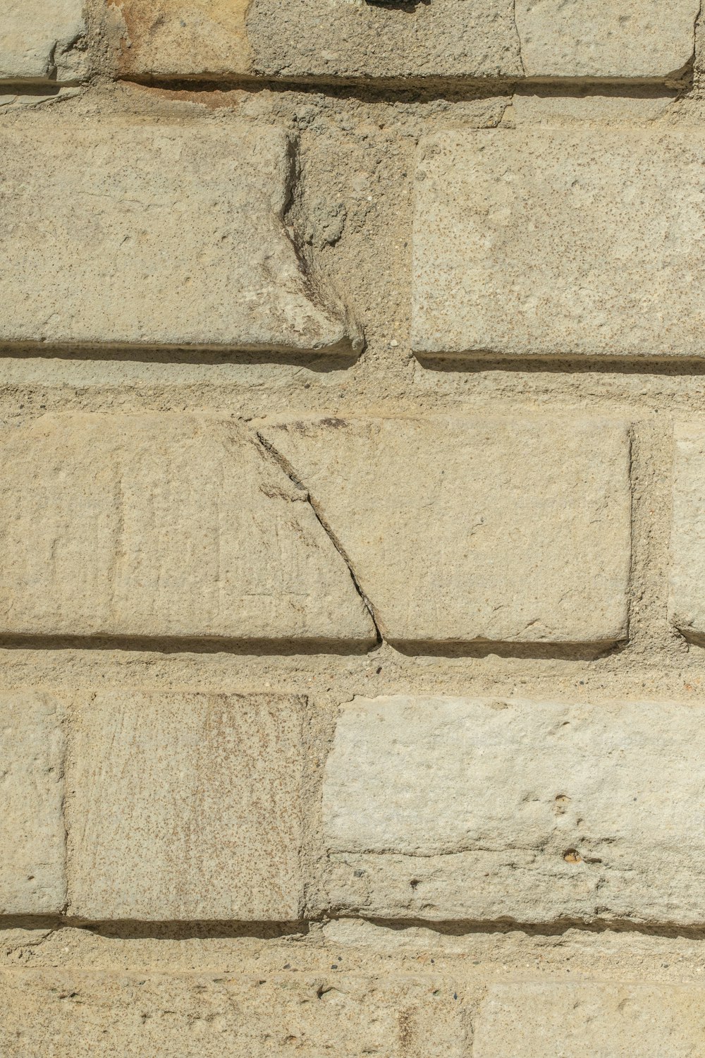 a close up of a brick wall with a clock on it