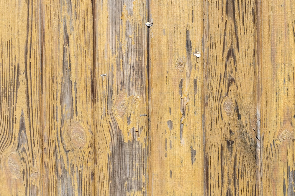 a close up of a wooden wall with a clock on it