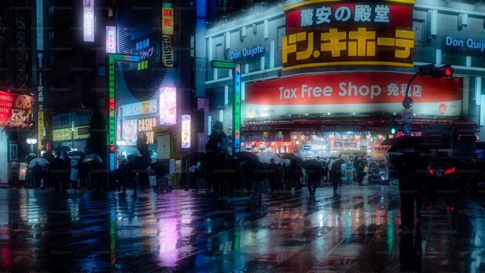 a group of people walking down a street at night