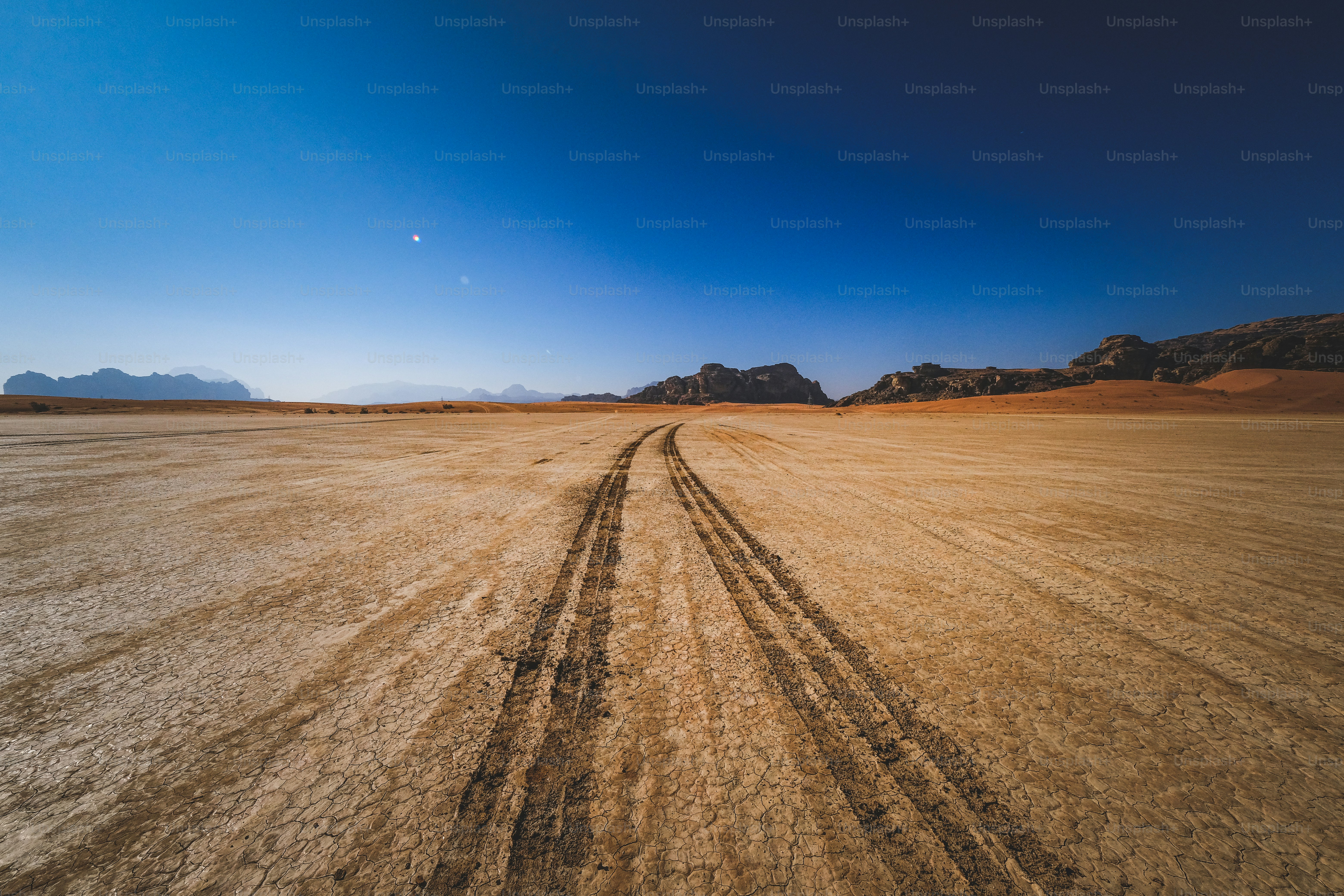 a dirt road in the middle of a desert