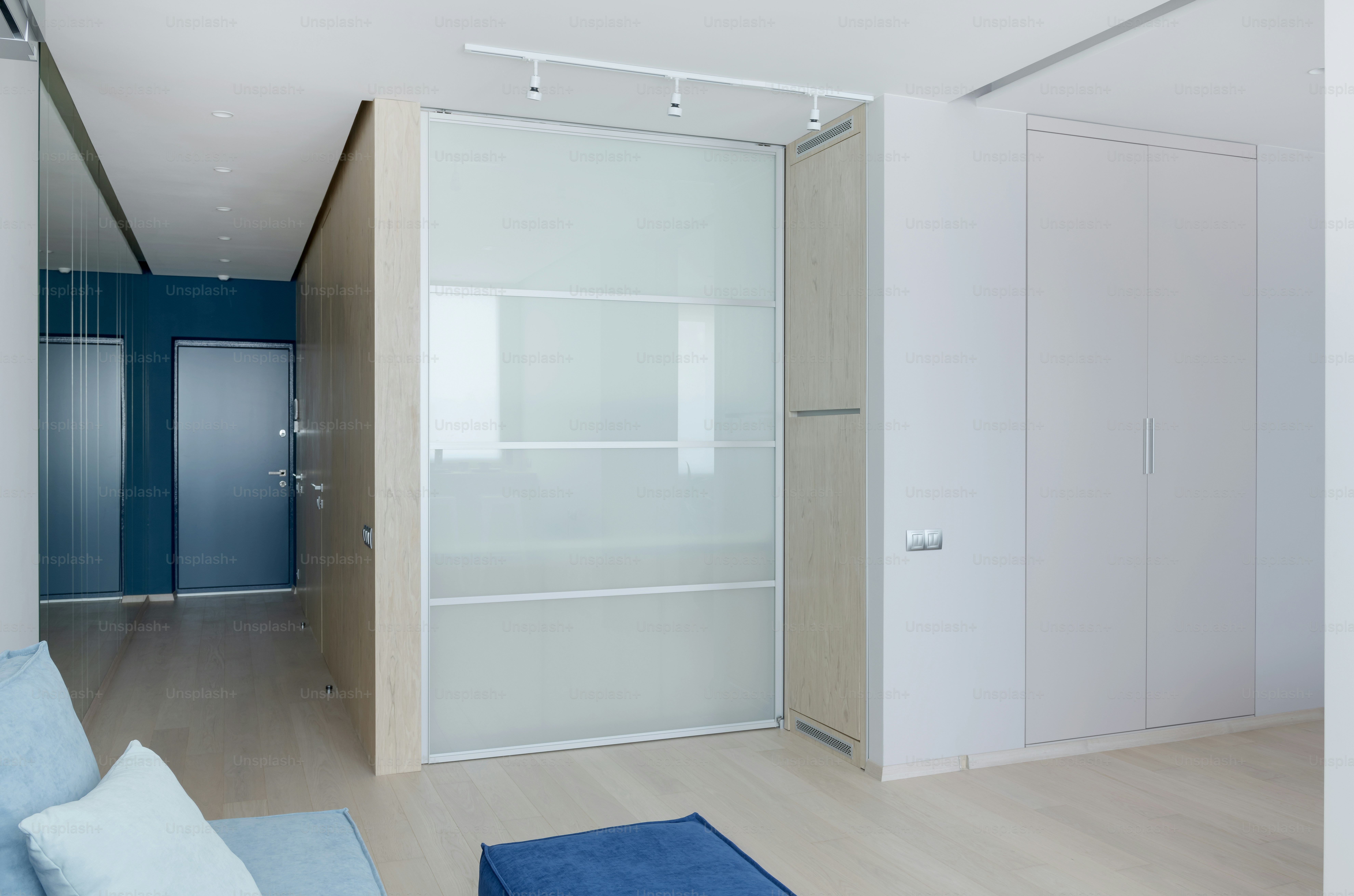 a living room with a couch and a sliding glass door