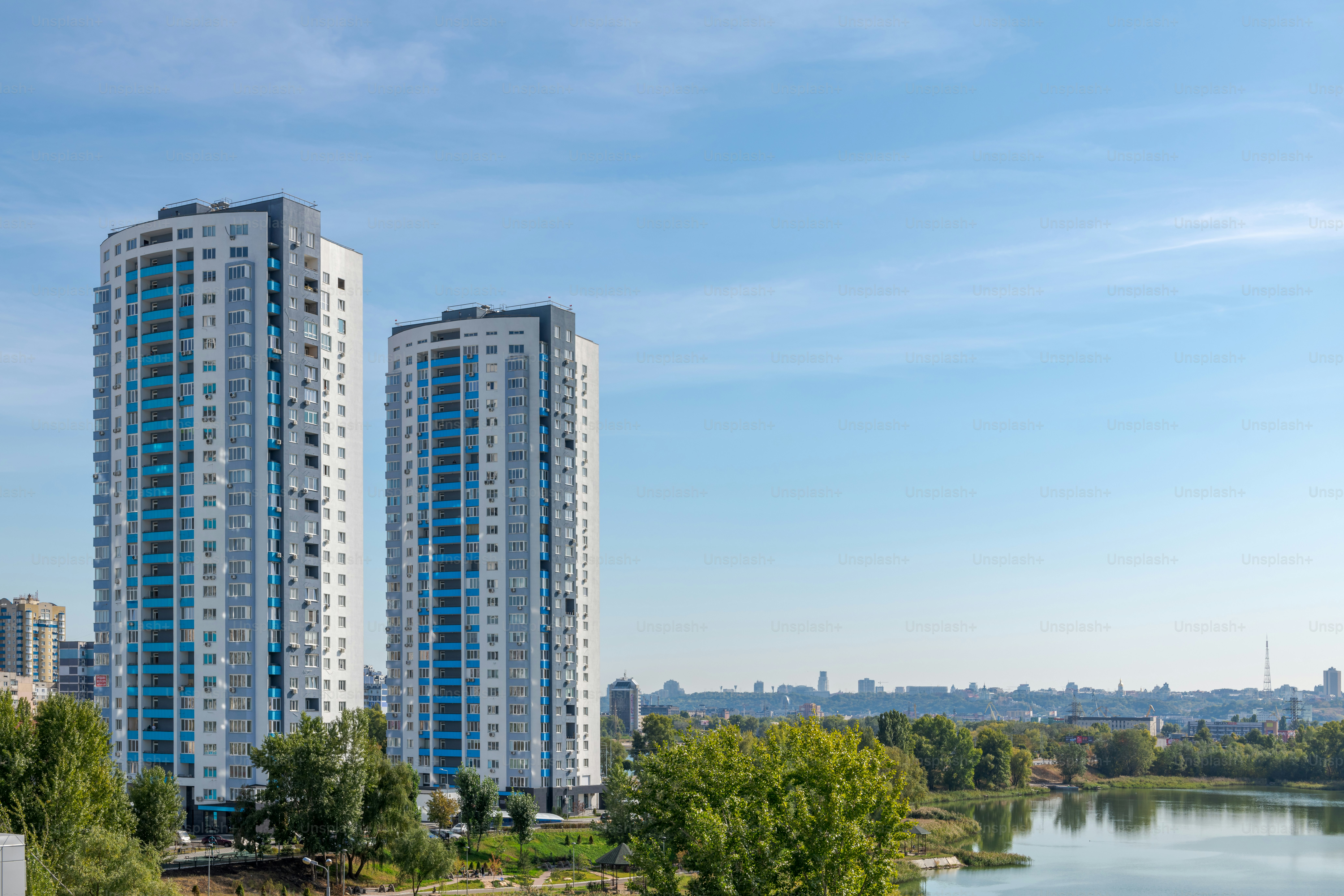 a couple of tall buildings sitting next to a river