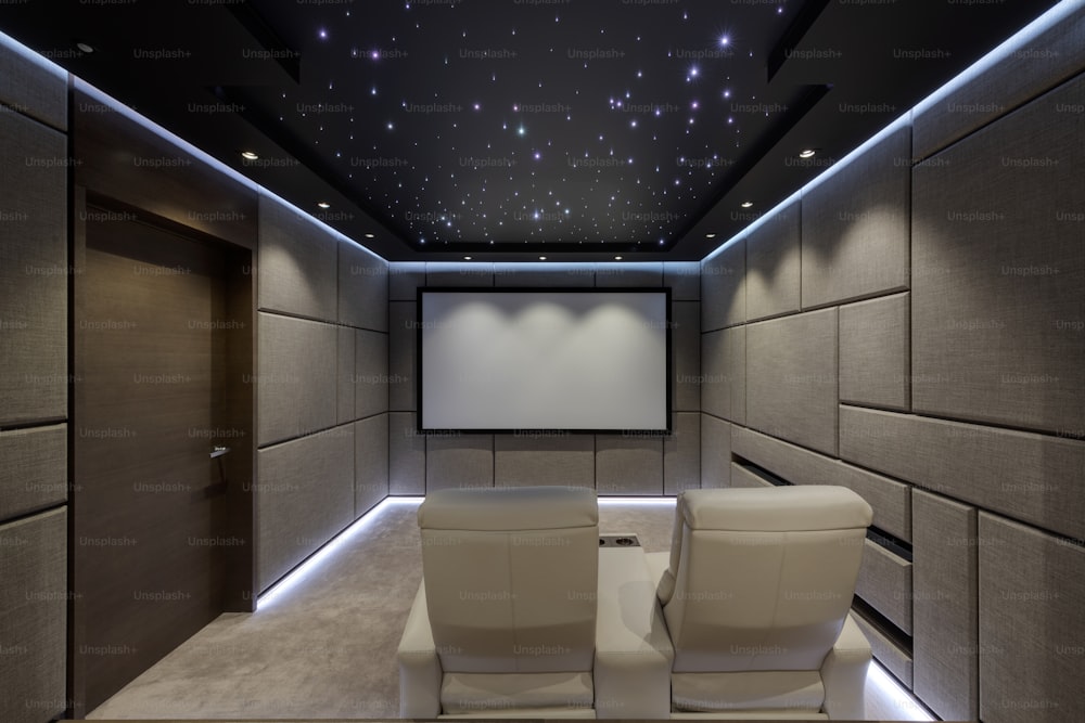 a room with two chairs and a projector screen