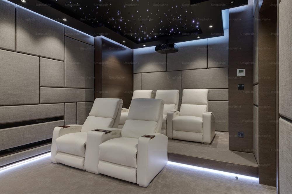 a home theater with two recliners in the middle of the room