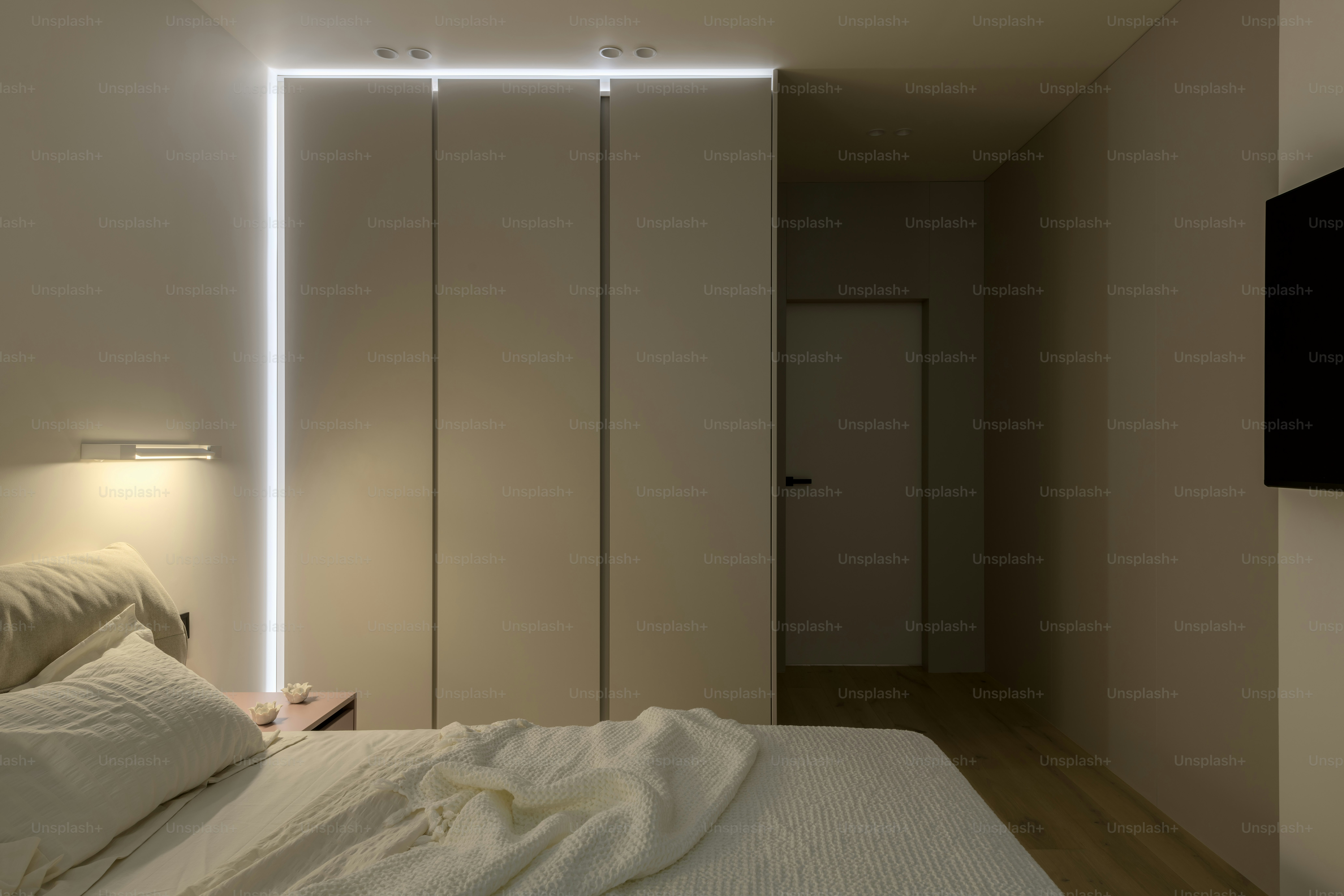 a bedroom with a white bed and a white closet