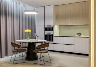 a kitchen with a table, chairs and a stove