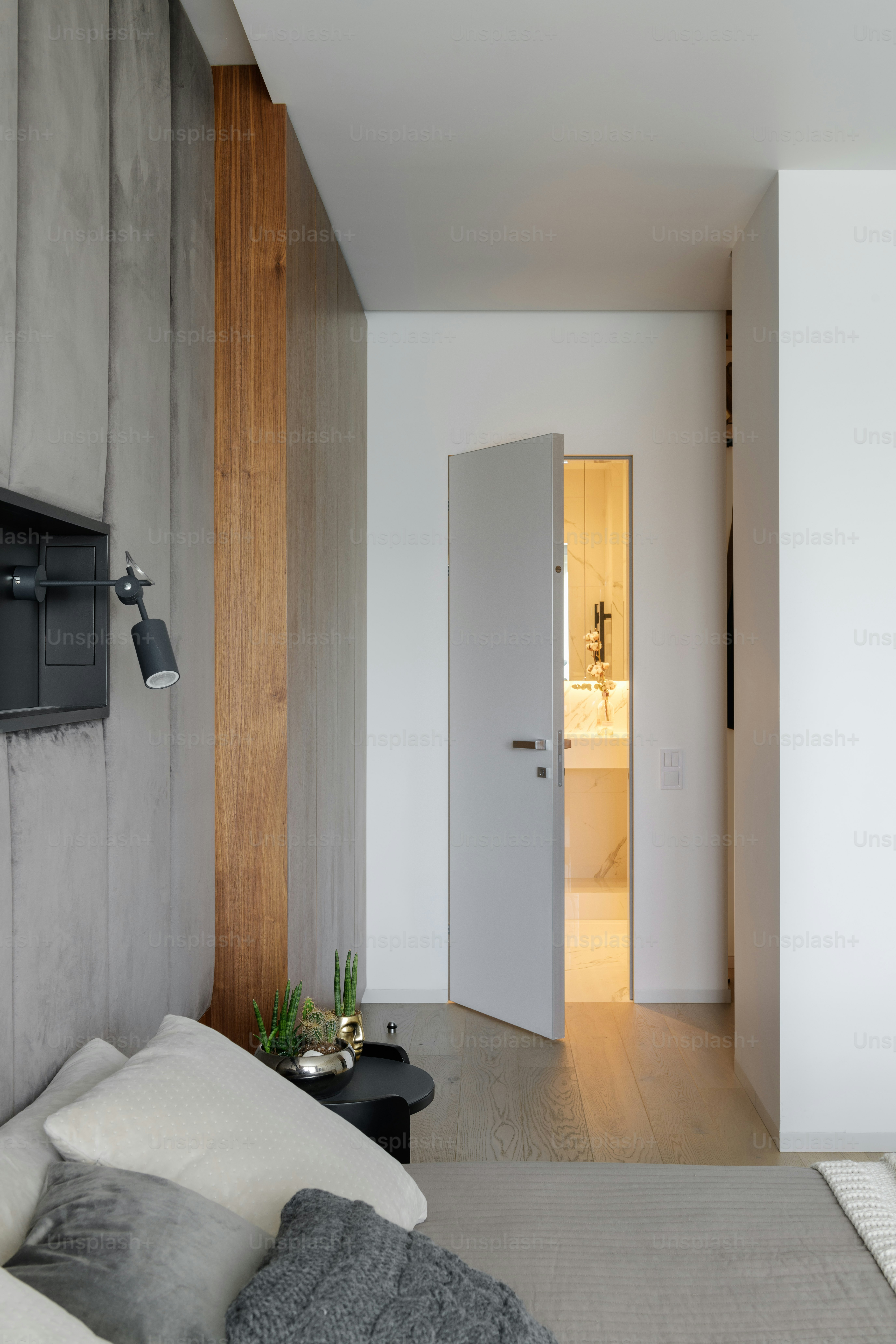 a bed sitting in a bedroom next to a white door