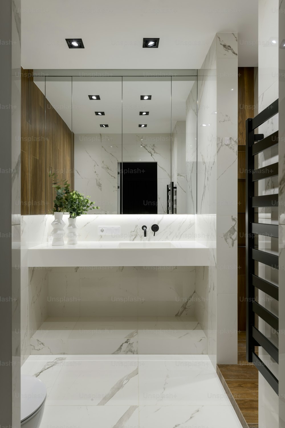 uma casa de banho com um espelho grande e um lavatório