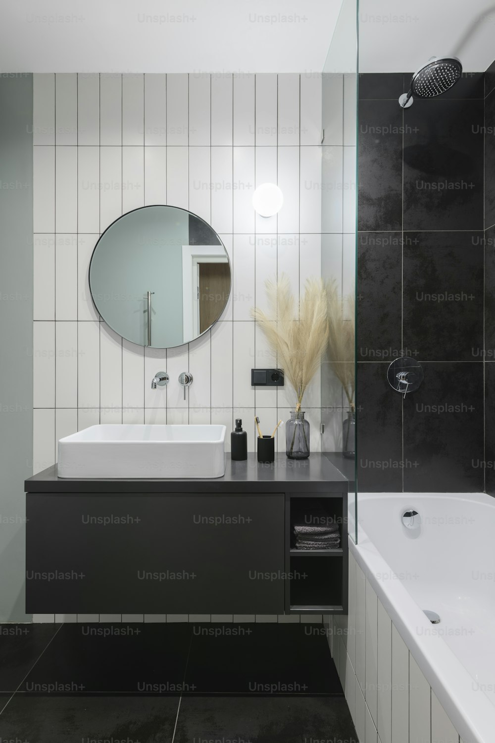 a black and white bathroom with a large mirror