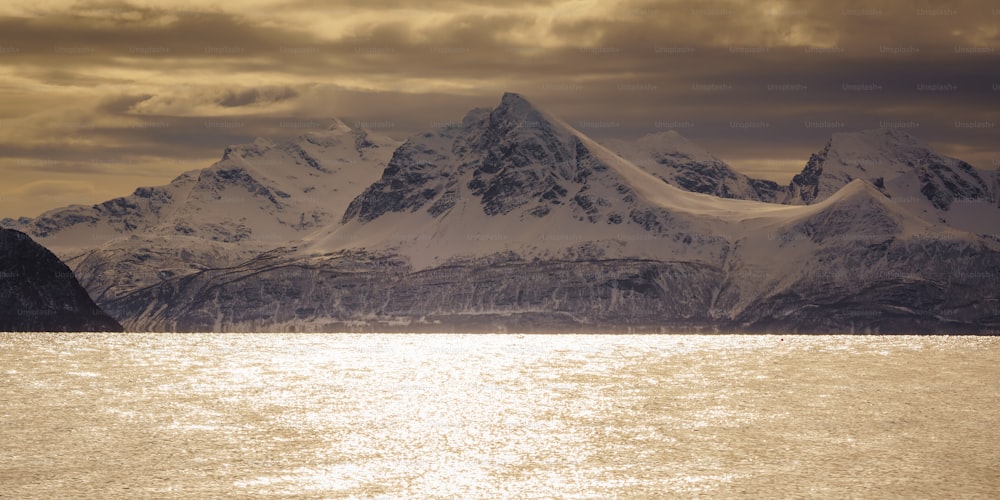 a mountain range with a body of water in front of it