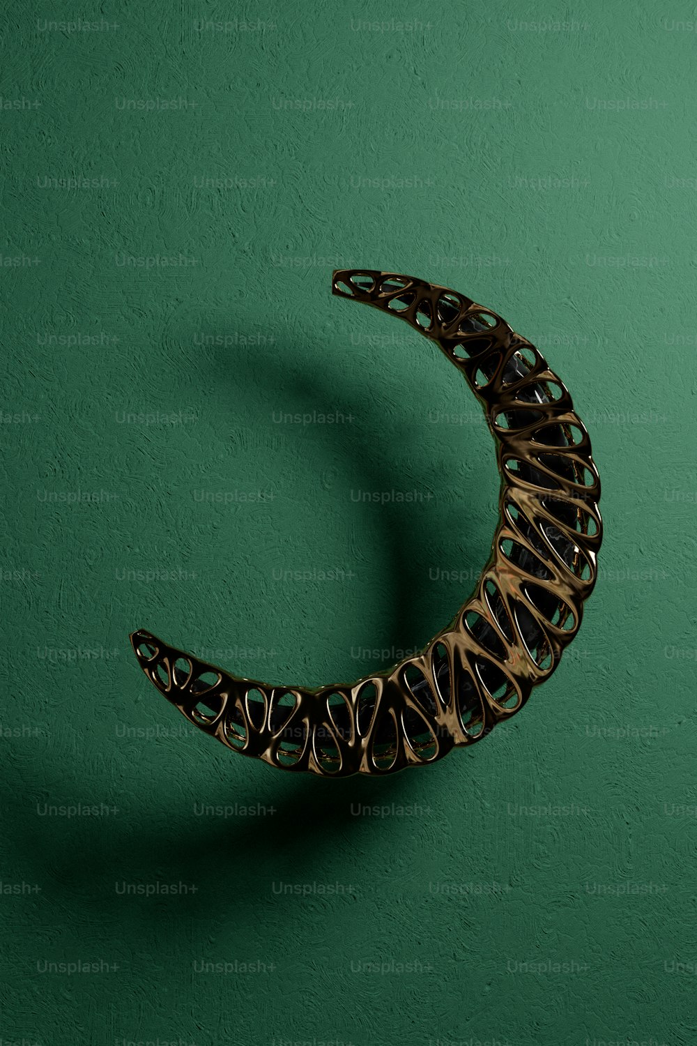 a sculpture of a crescent on a green wall