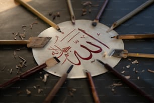 a circle of pencils with a calligraphy on it