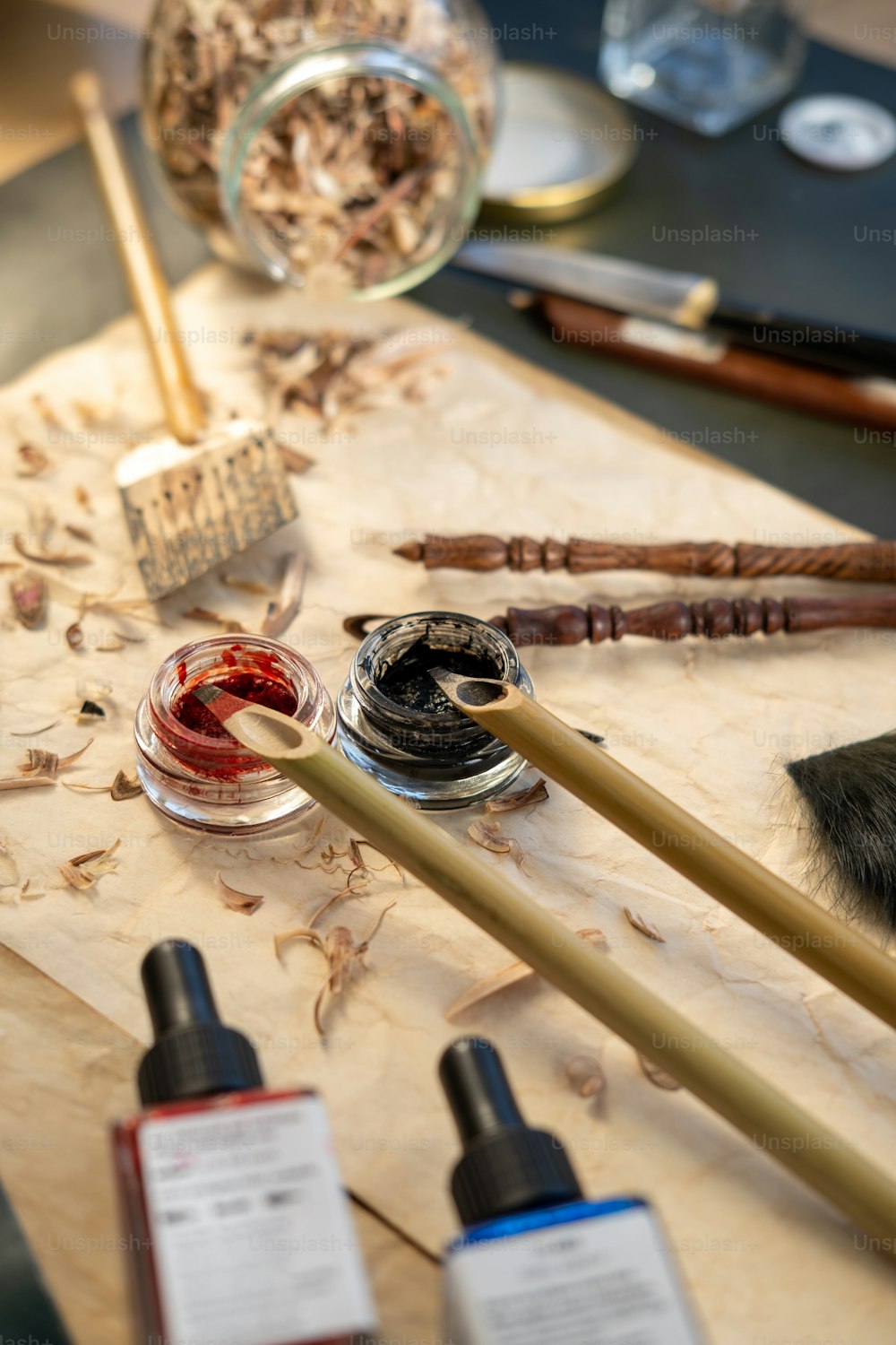 a table topped with lots of different types of paint and brushes