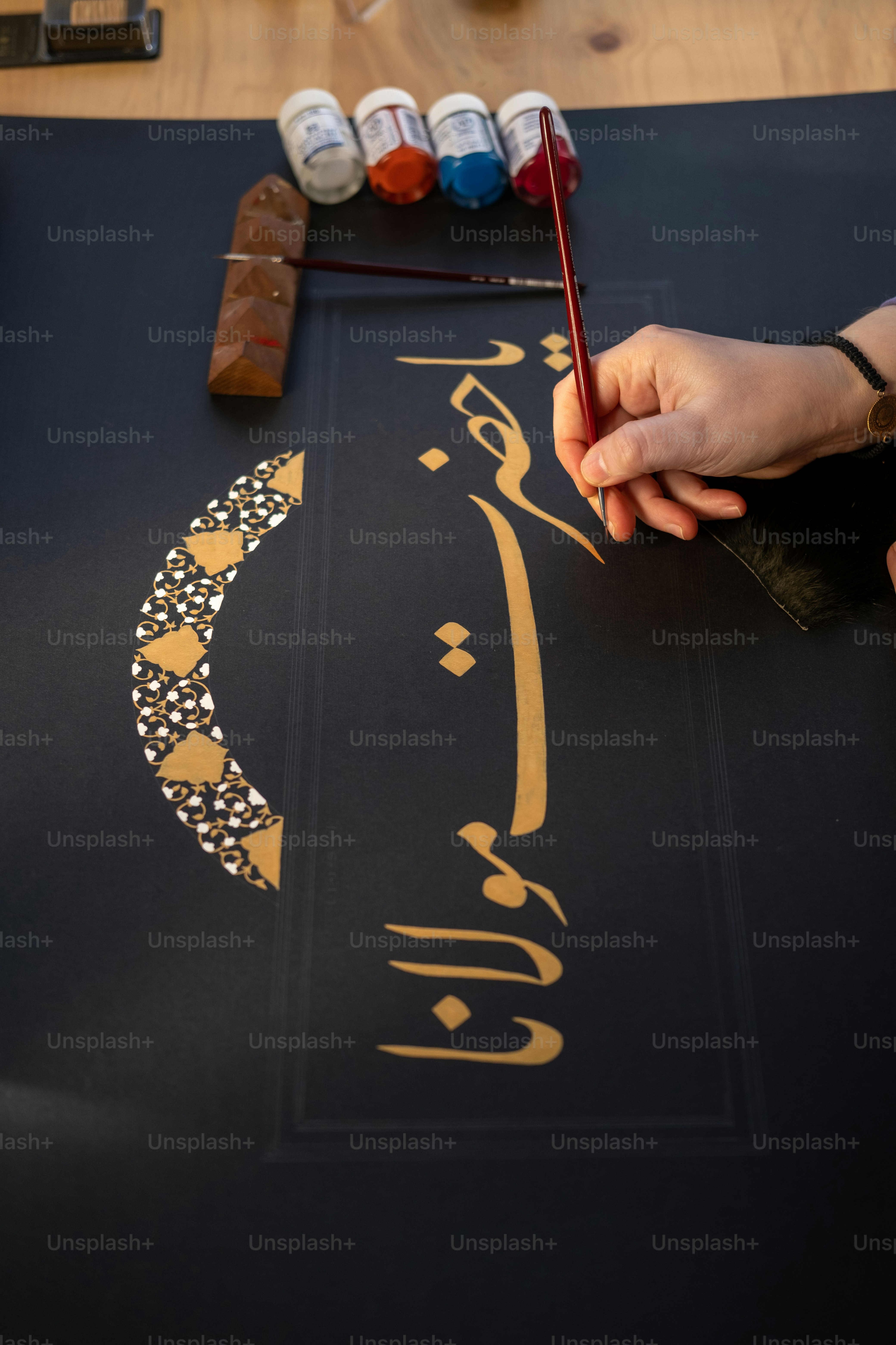 a person is painting a picture on a table