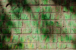 una pared de ladrillo con pintura verde