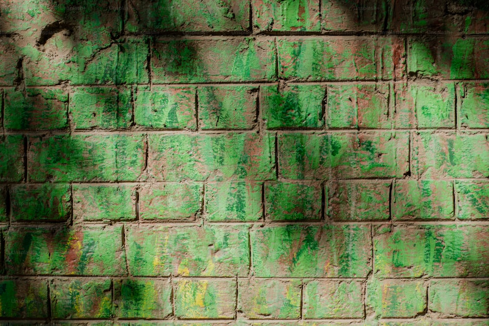 a brick wall with green paint on it