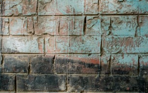 a brick wall with a red and blue paint on it