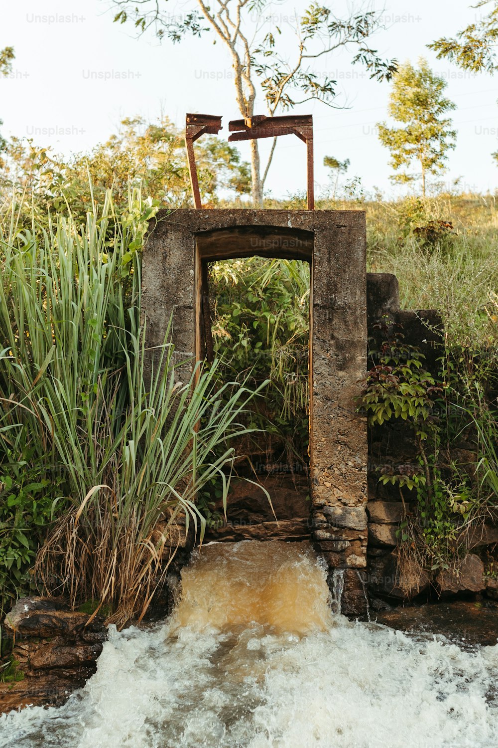 a small stream running through a stone bridge