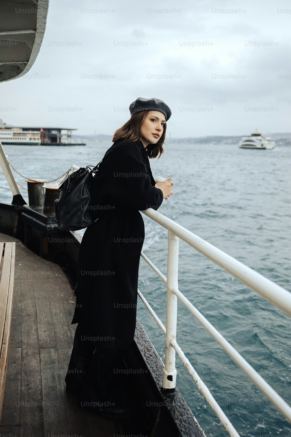 a woman is standing on the deck of a boat