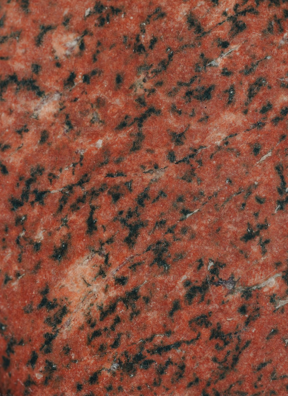 a close up of a red granite surface