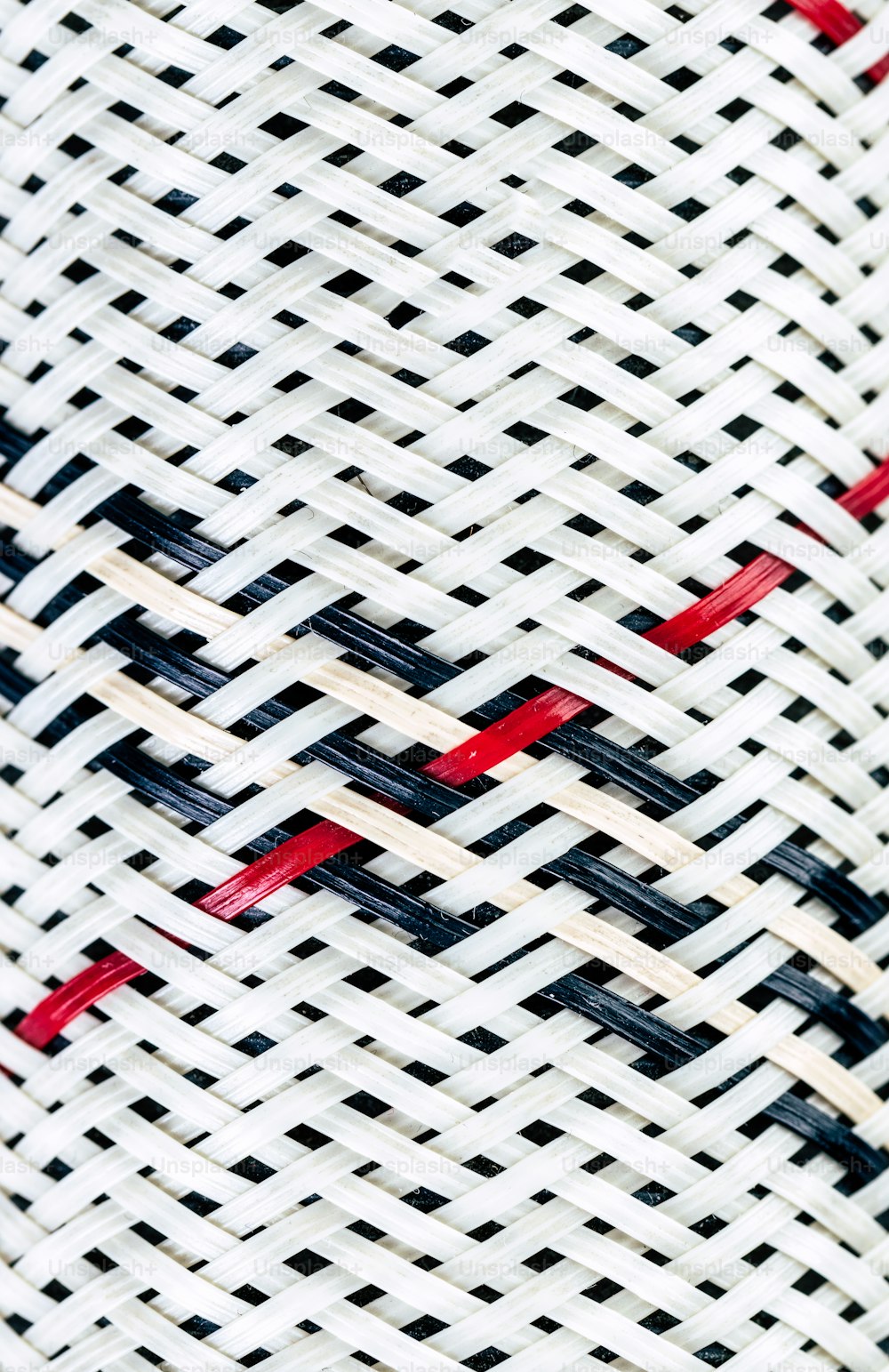a close up of a white and red woven material