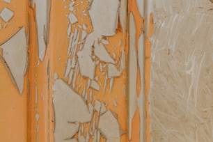 a close up of peeling paint on a wall