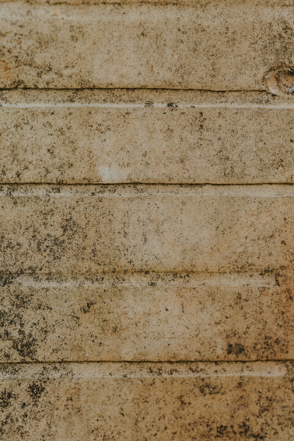 a close up of a clock on a brick wall