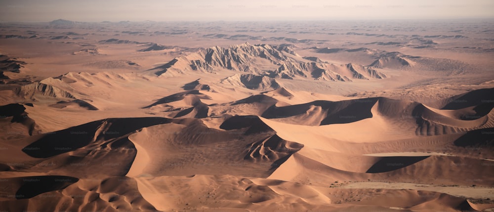 an aerial view of a desert with sand dunes