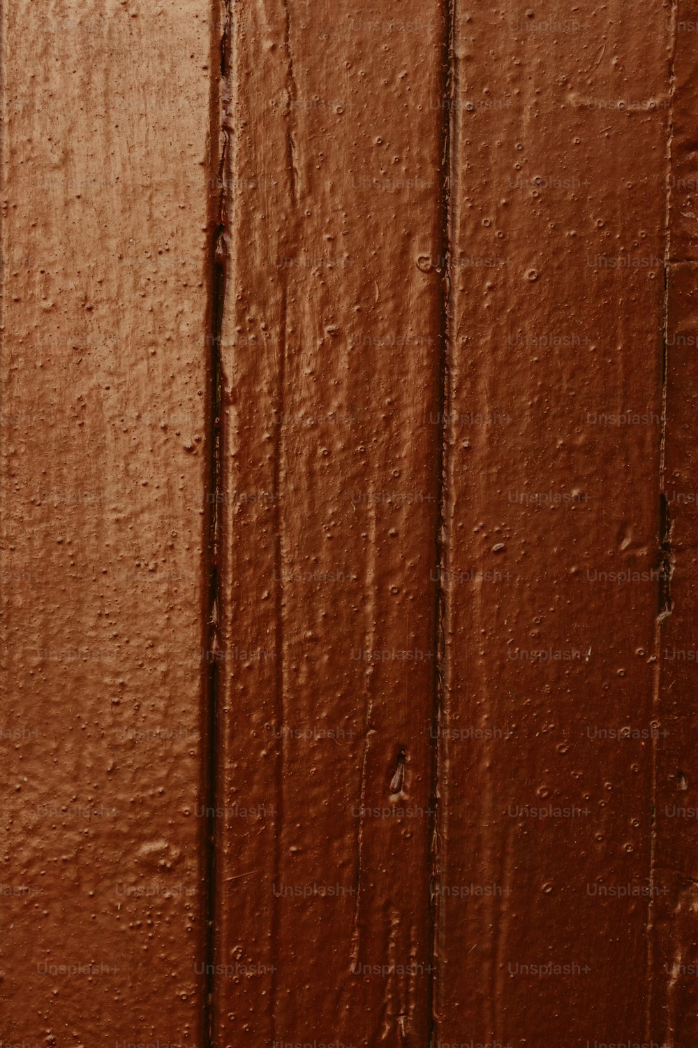 a close up of a wooden door with water droplets on it