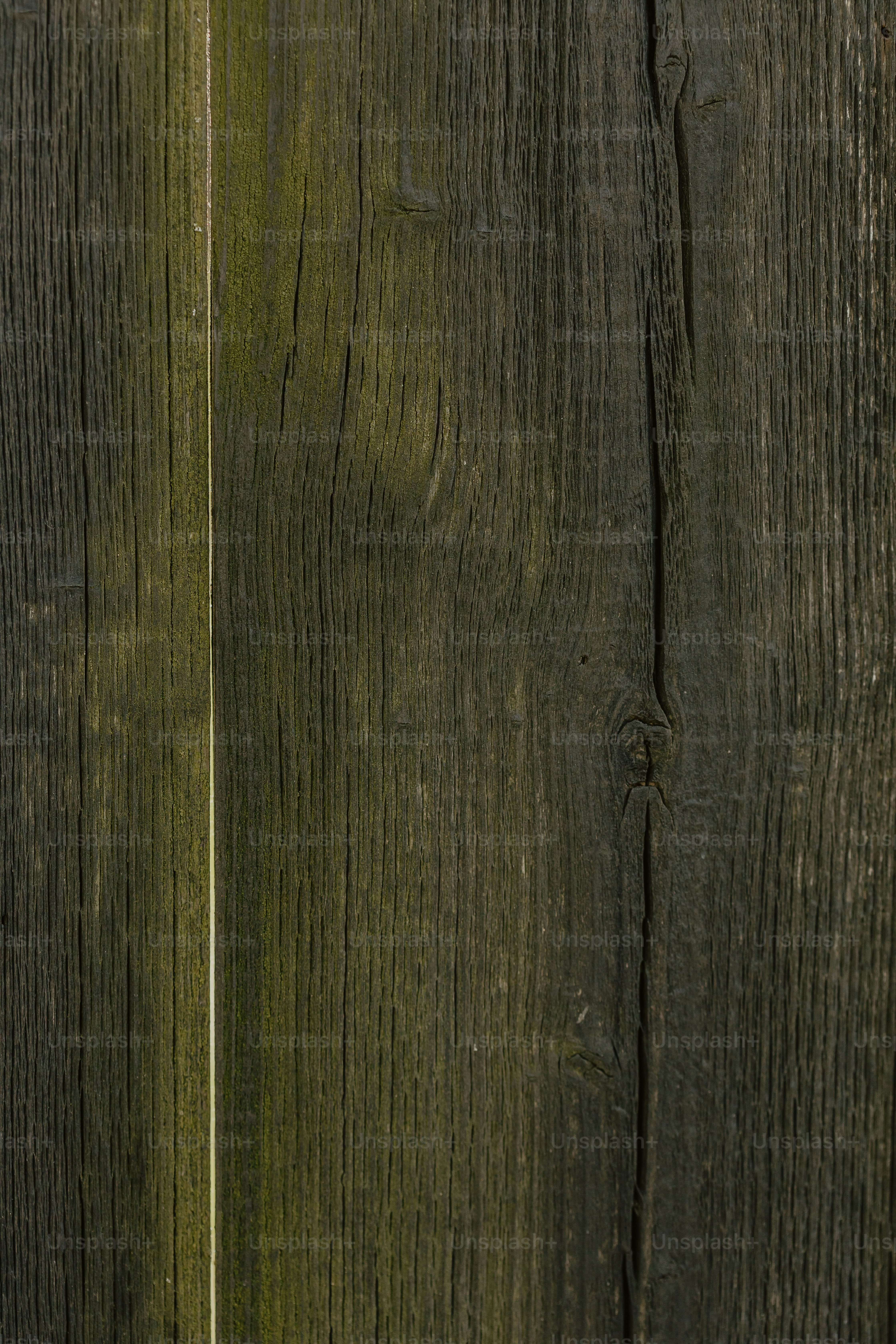 a close up of a wooden fence with a cell phone