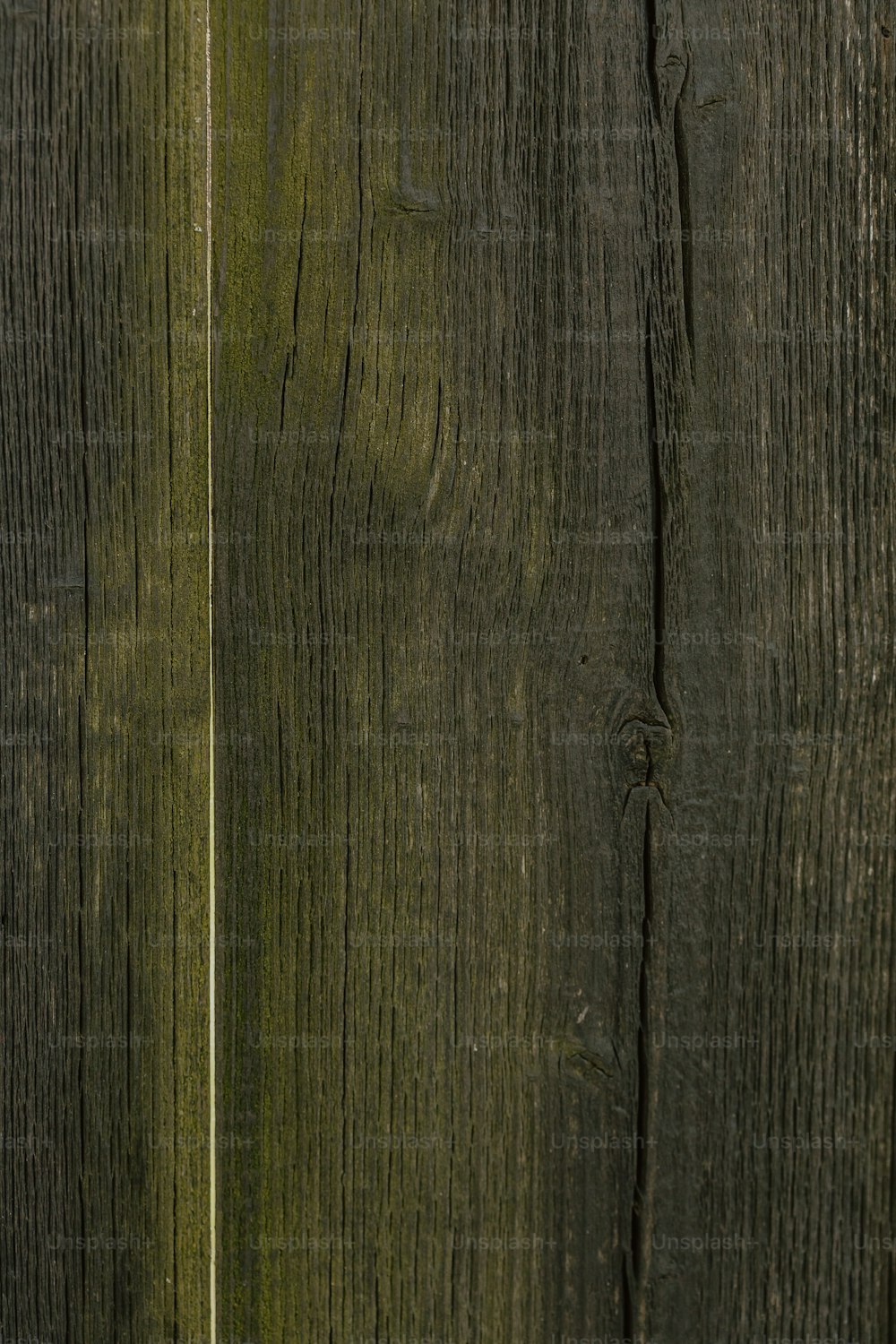 a close up of a wooden fence with a cell phone
