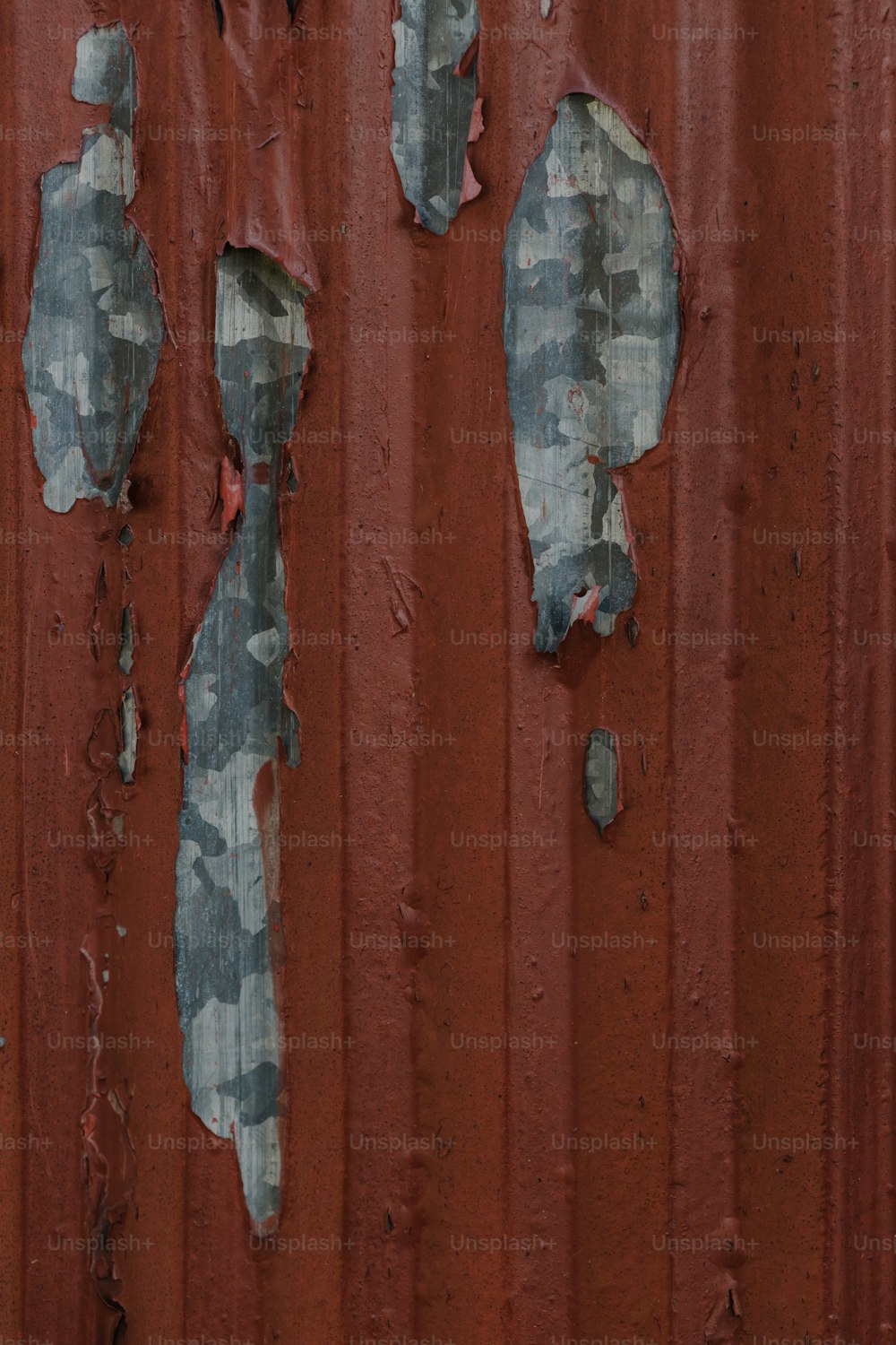 a rusted metal wall with peeling paint on it