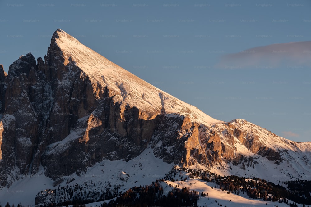 a snow covered mountain with a sky background