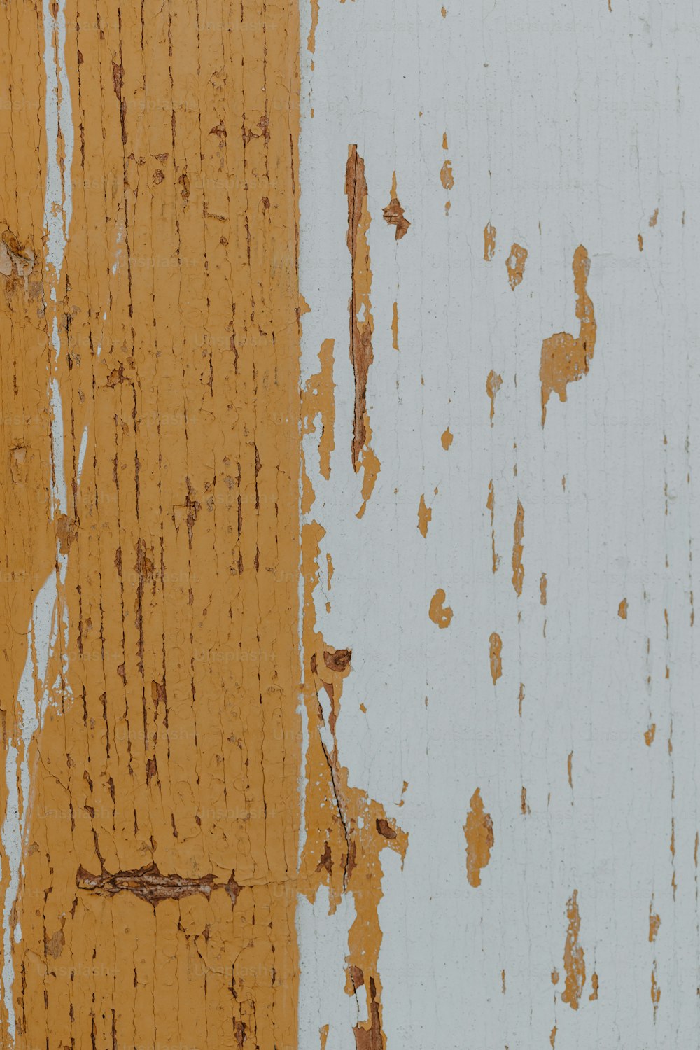 a close up of peeling paint on a wall