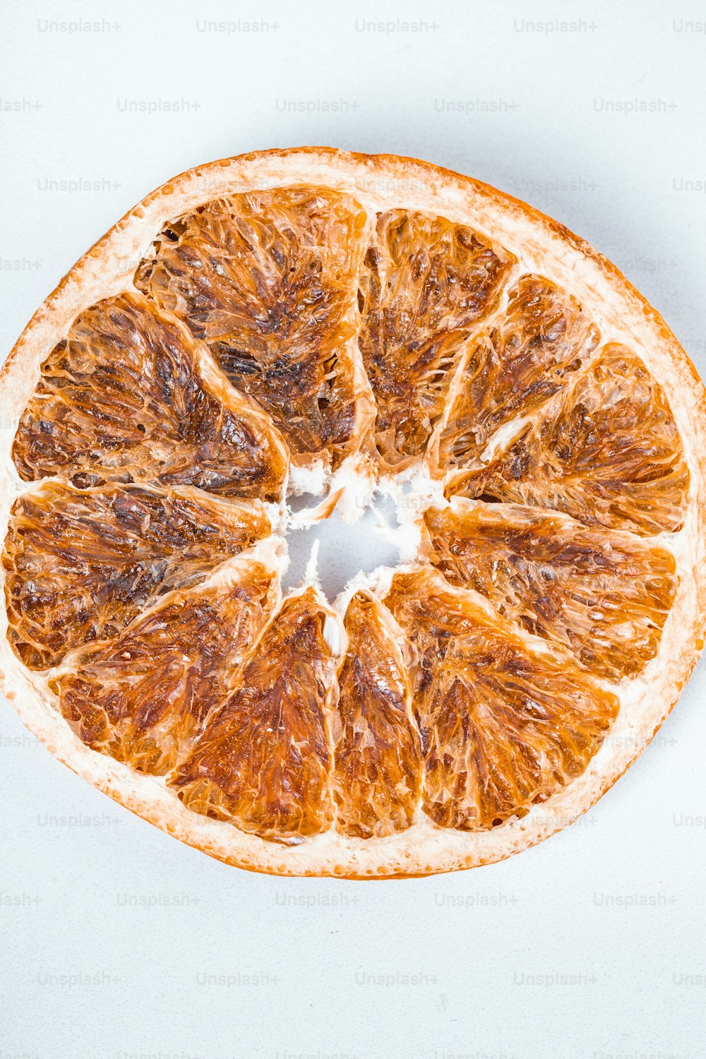 an orange cut in half on a white surface